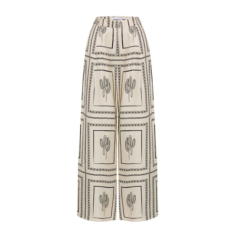 Elegante tweedelige dames outfit met geometrisch patroon: blouse en pantalon met wijde pijpen